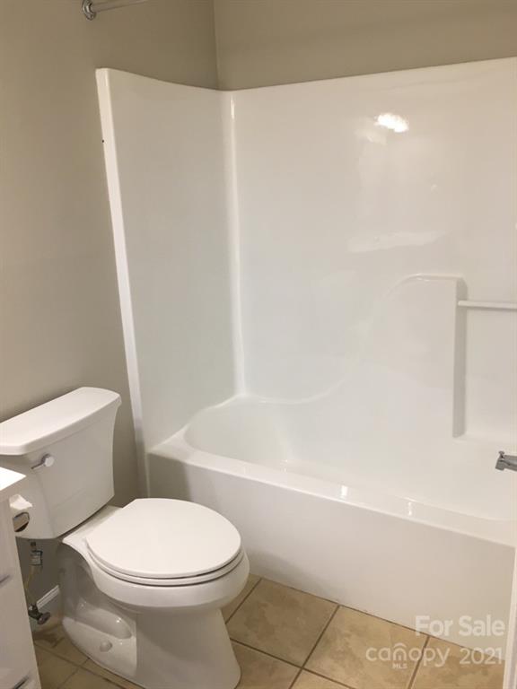 58 Ross Farm Road Waynesville, NC 28786 - Photo 25 of 29 a white toilet sitting next to a bath tub