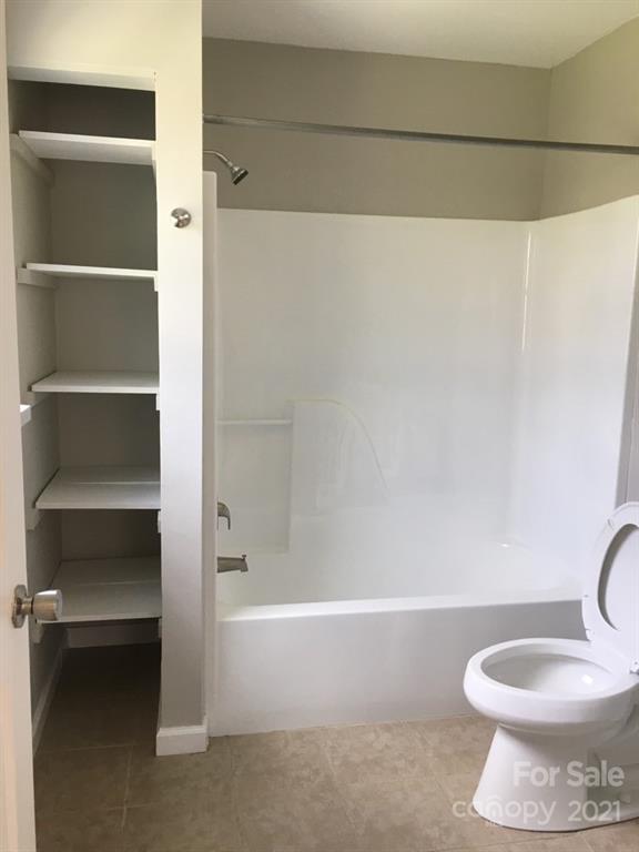 58 Ross Farm Road Waynesville, NC 28786 - Photo 26 of 29 a bathroom with a toilet and a bathtub