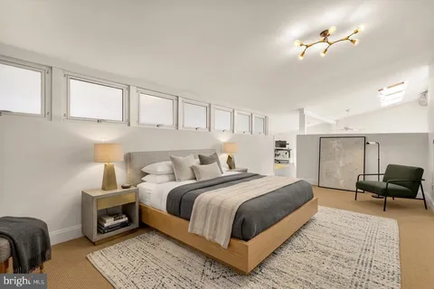 a bedroom with bed and a chandelier
