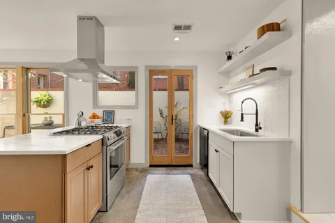 a kitchen with a sink stove and refrigerator