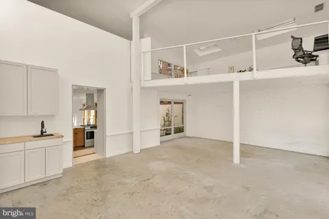 a view of a kitchen with a sink and cabinets