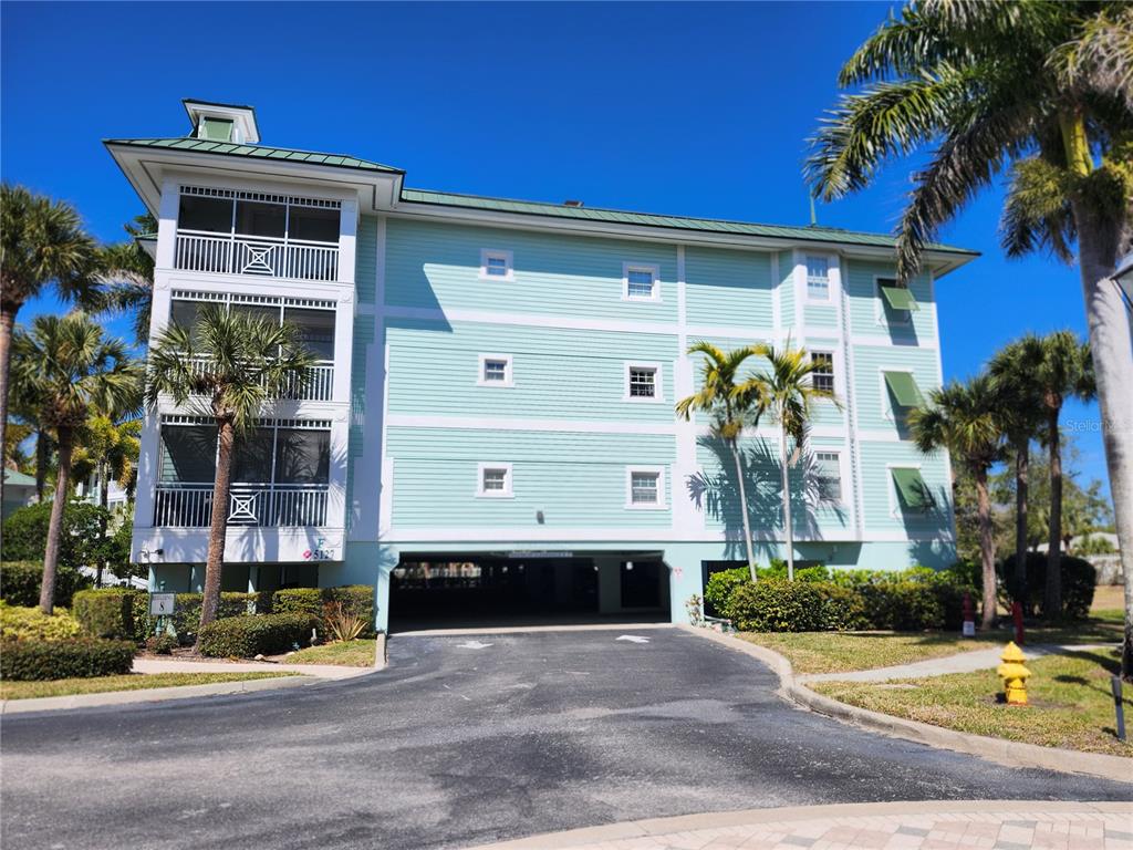 5127 Melbourne Street, Unit F103 Punta Gorda, FL 33980 - Photo 1 of 69 a front view of a house with a yard