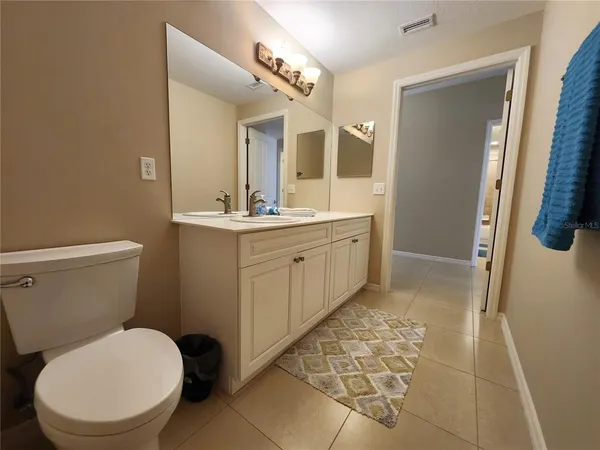 a bedroom with a bed and a flat tv screen in it