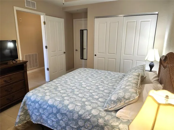 a white refrigerator freezer sitting in a kitchen with white cabinets