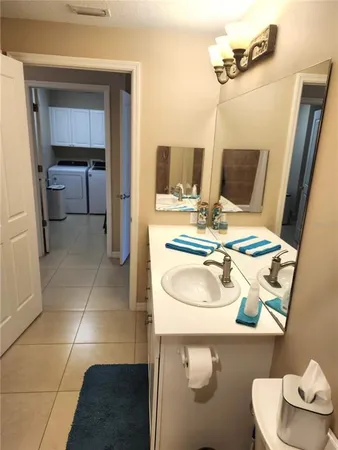 a large kitchen with granite countertop a stove a sink a table and chairs