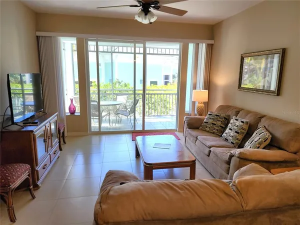 a living room with furniture and a chandelier