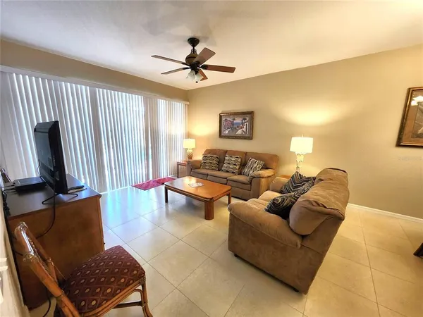 a bedroom with two beds and a chandelier