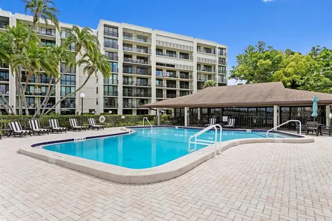 a view of house with swimming pool and outdoor seating