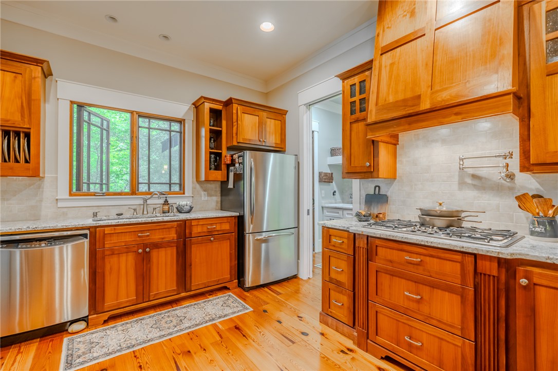 102 State Rd S-39-143 Sunset, SC 29685 - Photo 19 of 47 This spacious kitchen offers ample wood cabinetry and granite countertops, perfect for culinary endeavors.