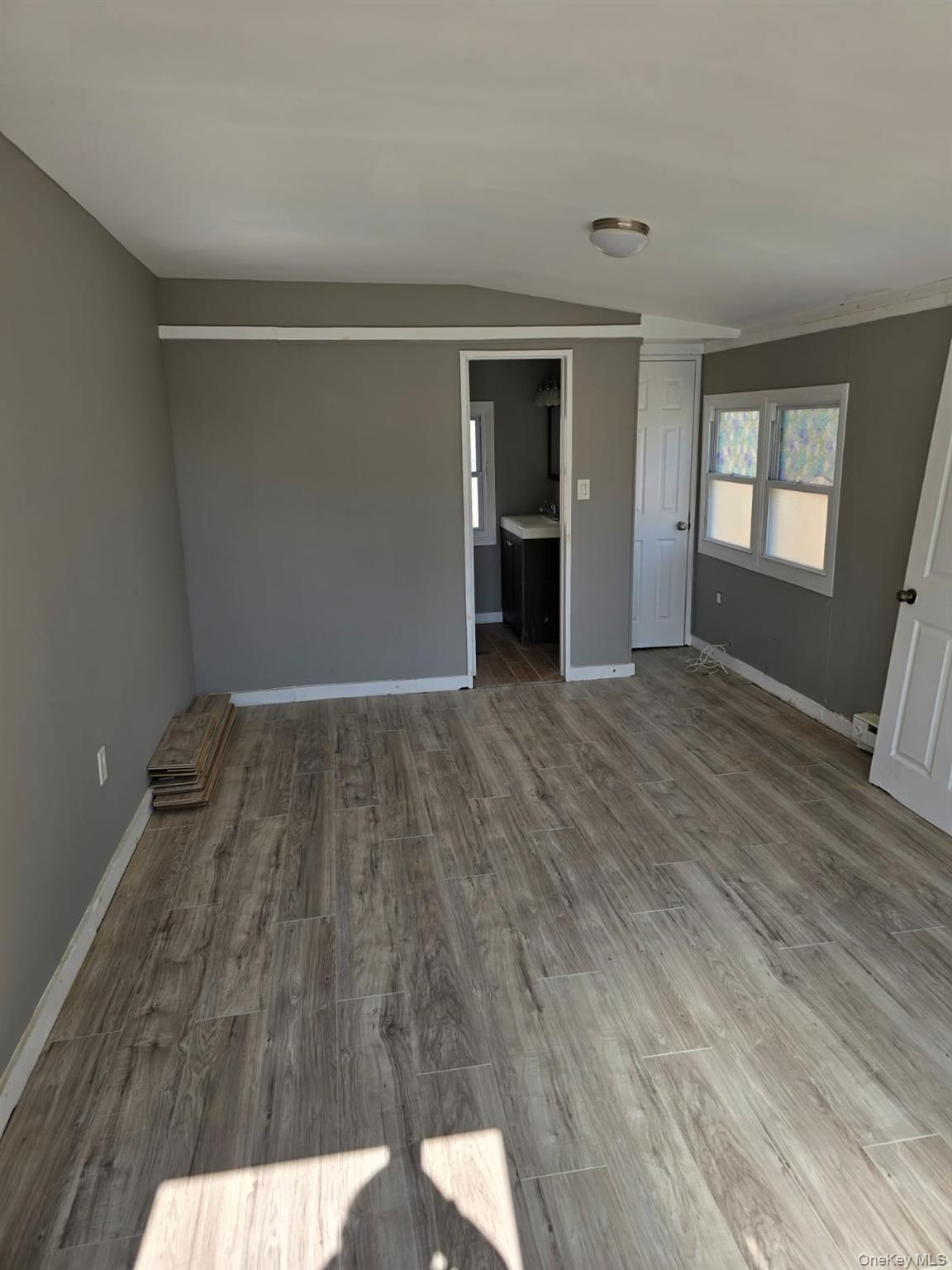 31 Cold Spring Road Monticello, NY 12701 - Photo 6 of 11 a view of an empty room with wooden floor and a window