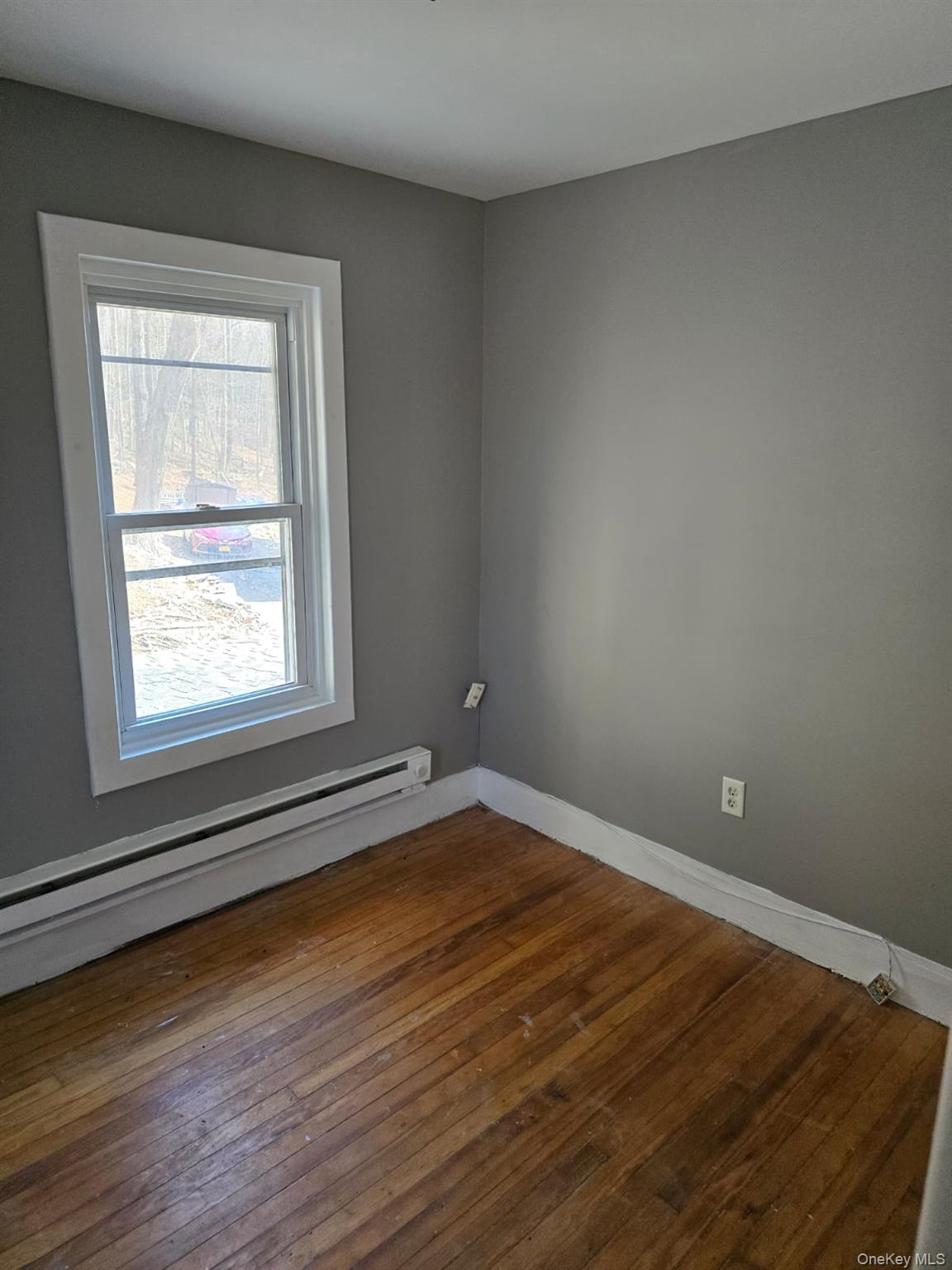 31 Cold Spring Road Monticello, NY 12701 - Photo 9 of 11 a view of an empty room with wooden floor and a window