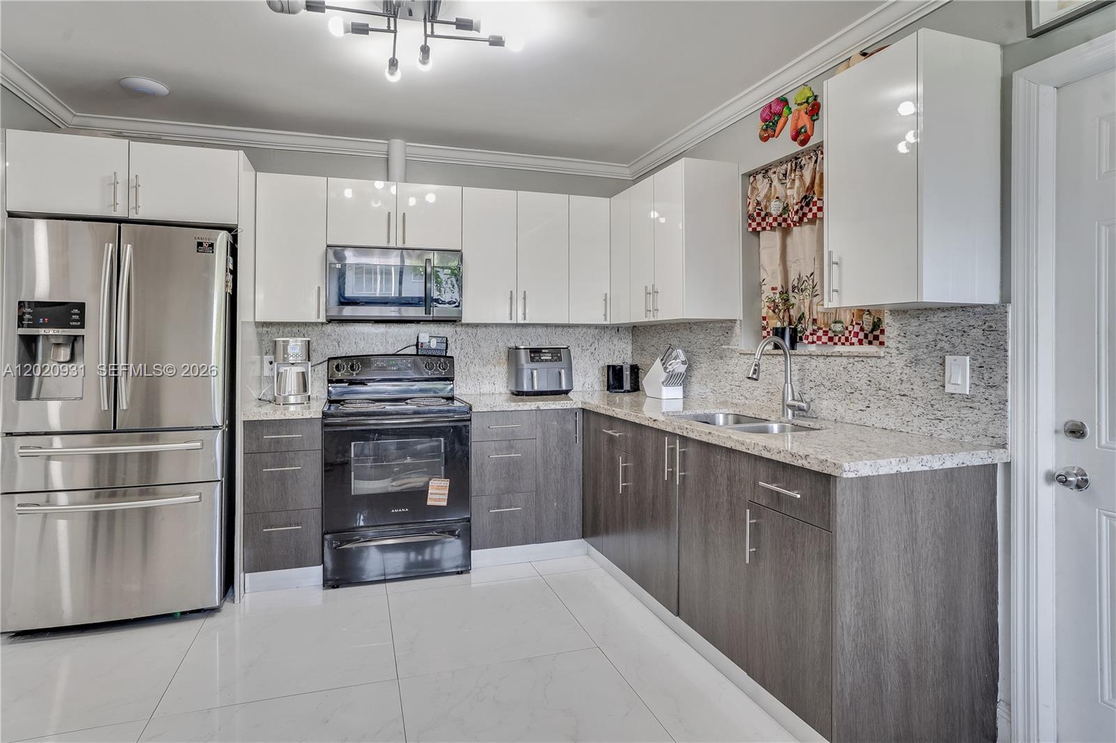 1360 Northwest 77th Street Miami, FL 33147 - Photo 10 of 41 a kitchen with a sink stainless steel appliances and cabinets