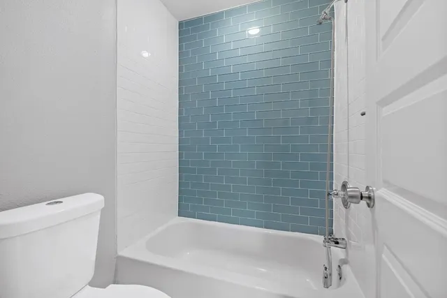 an empty room with wooden floor and window