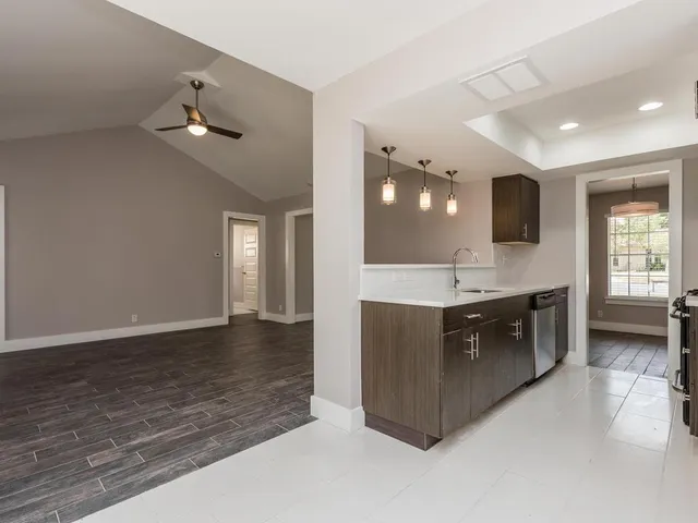 a kitchen with a sink and a stove top oven
