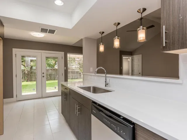 a kitchen with a sink and large window