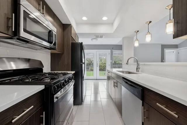 a kitchen with a sink stove and microwave