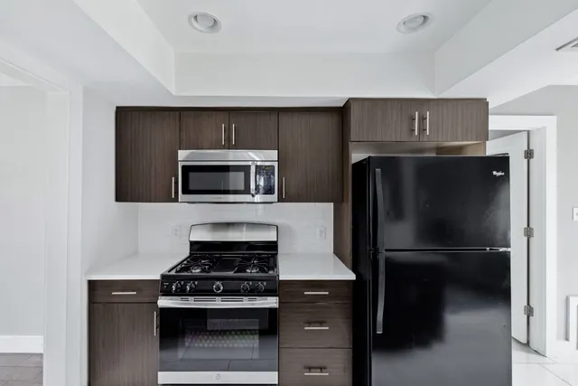 a kitchen with a stove and a refrigerator