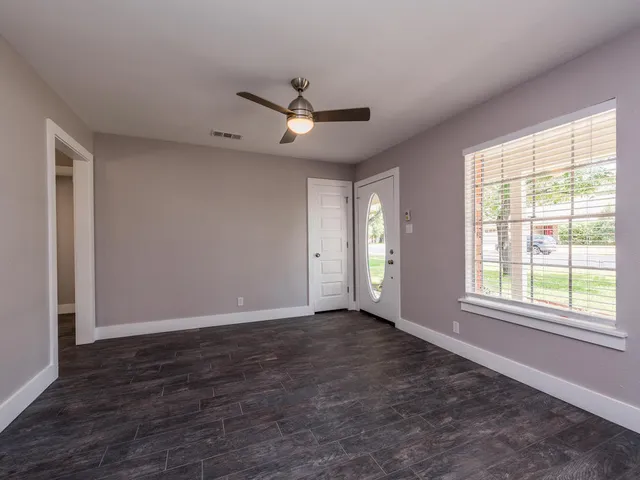 a view of an empty room with a window
