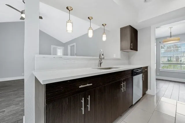 a kitchen with a sink and a refrigerator