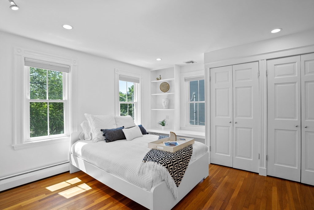 81 Franklin Street Brookline, MA 02445 - Photo 13 of 25 a bedroom with a bed and wooden floor