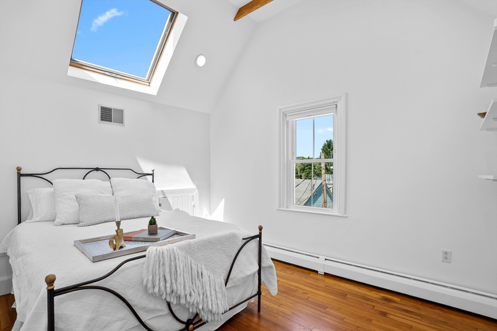 81 Franklin Street Brookline, MA 02445 - Photo 18 of 25 a view of a bedroom with furniture and wooden floor