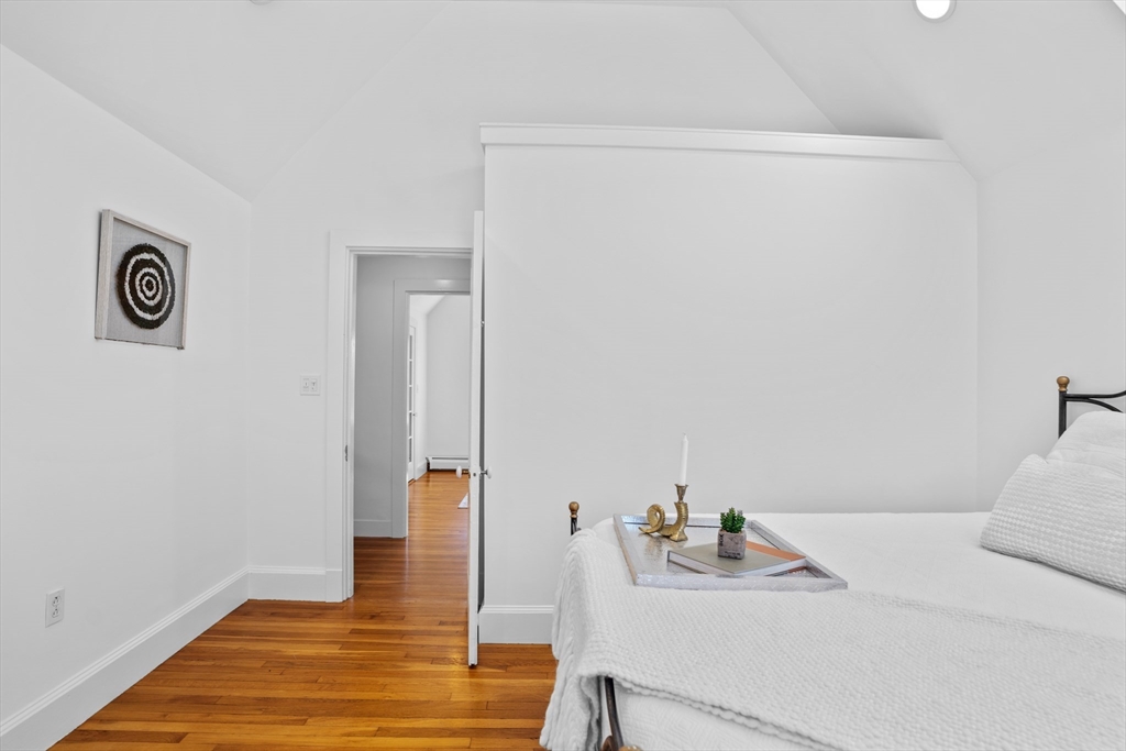 81 Franklin Street Brookline, MA 02445 - Photo 19 of 25 a bedroom with a bed and a table