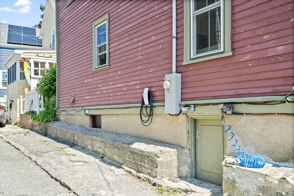 81 Franklin Street Brookline, MA 02445 - Photo 23 of 25 a view of a brick house with a backyard