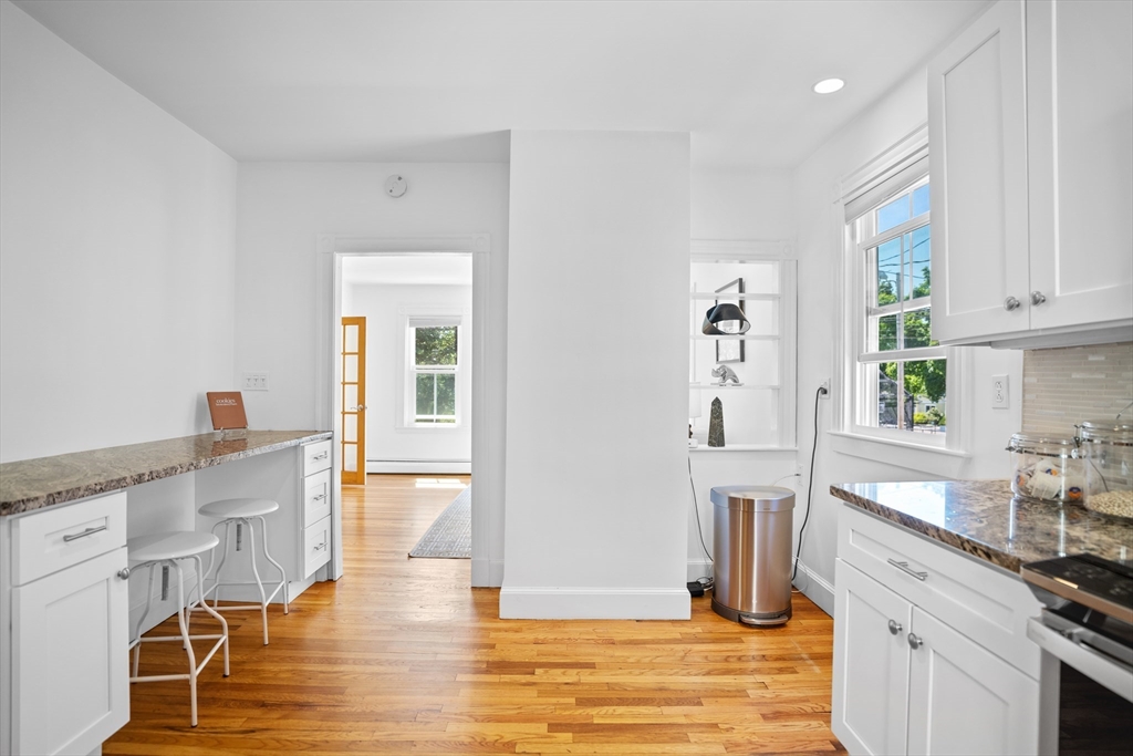 81 Franklin Street Brookline, MA 02445 - Photo 7 of 25 a kitchen with granite countertop a refrigerator and cabinets