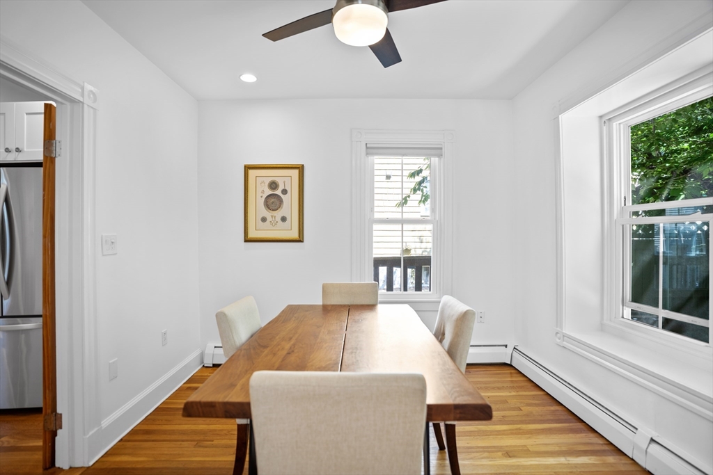 81 Franklin Street Brookline, MA 02445 - Photo 8 of 25 a view of a dining room with furniture a chandelier and wooden floor
