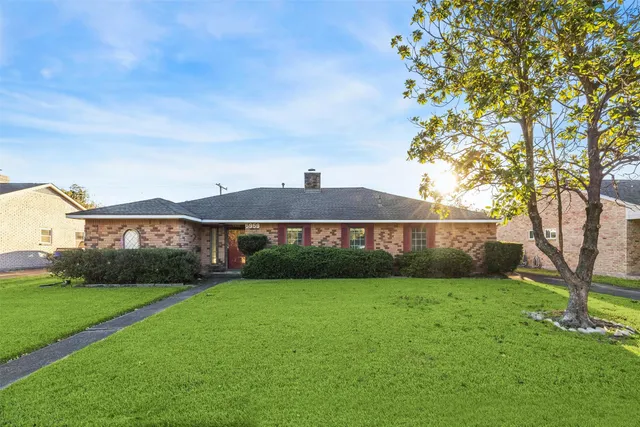 a view of a front of a house with a yard