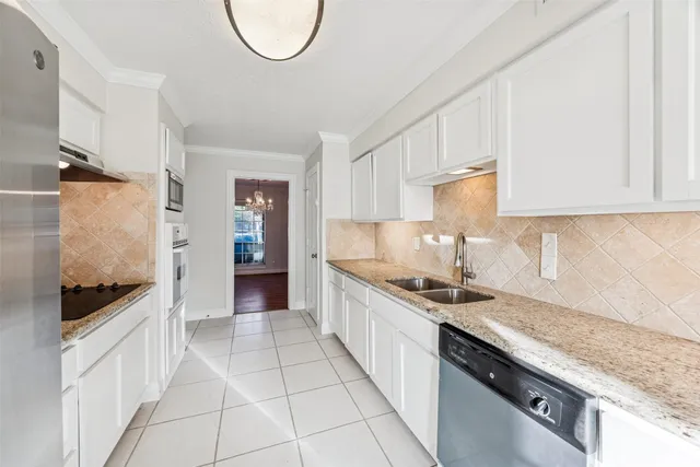a kitchen with granite countertop a sink and a stove