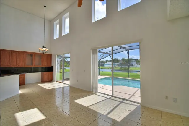 a view of room with ceiling fan and window