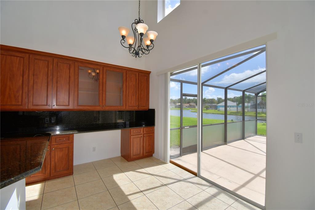 5368 Dahlia Reserve Drive Kissimmee, FL 34758 - Photo 21 of 83 a kitchen with stainless steel appliances granite countertop a stove a sink and dishwasher