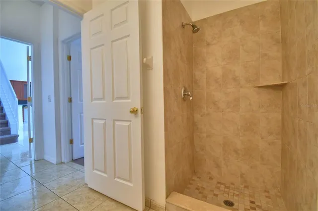 an empty room with a ceiling fan and a window