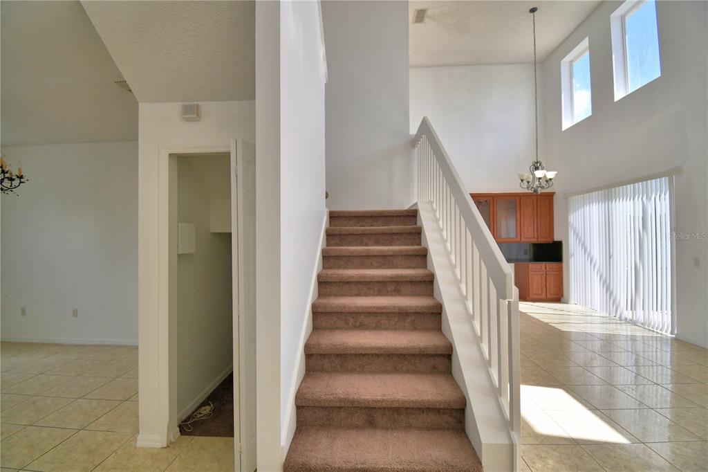 5368 Dahlia Reserve Drive Kissimmee, FL 34758 - Photo 33 of 83 a view of staircase with white walls and railing