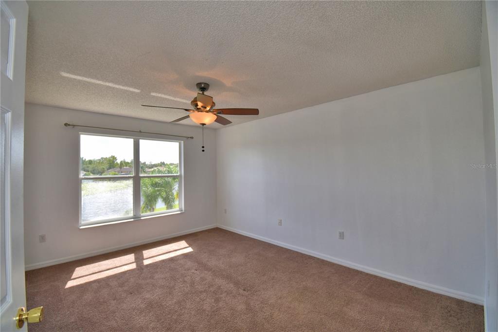 5368 Dahlia Reserve Drive Kissimmee, FL 34758 - Photo 37 of 83 an empty room with windows and fan
