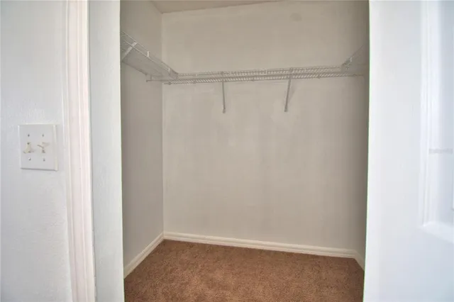 a bathroom with a granite countertop sink a mirror and a toilet