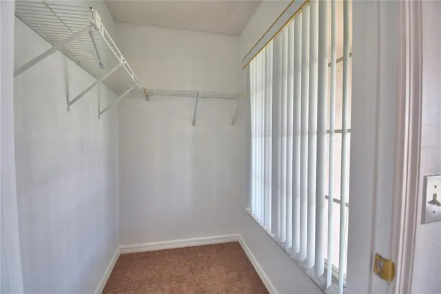 a view of a backyard with table and chairs under an umbrella