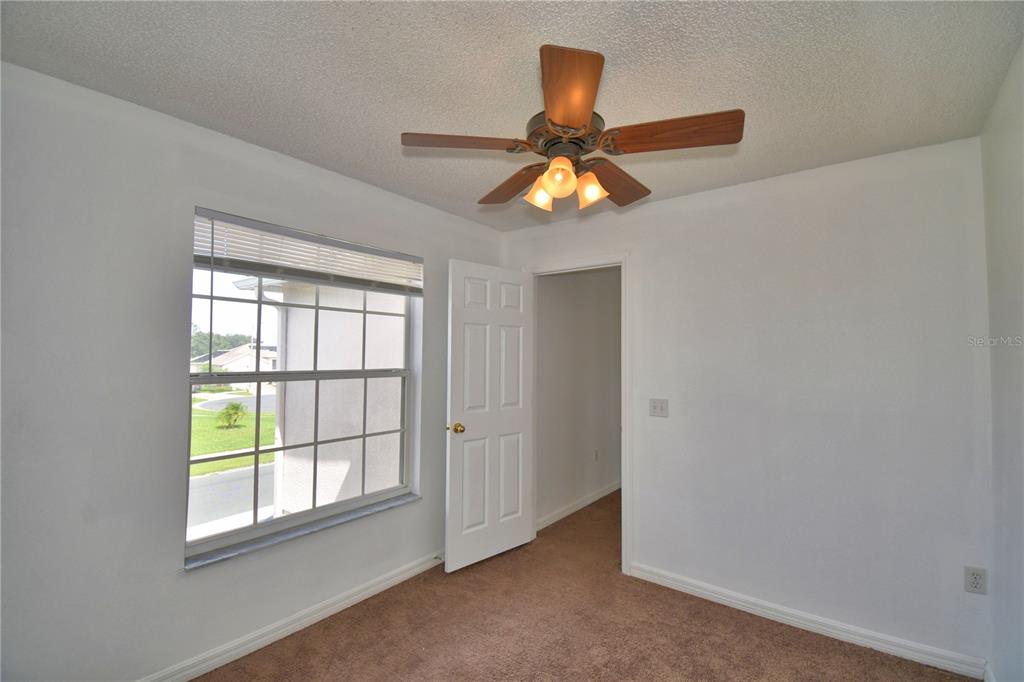 5368 Dahlia Reserve Drive Kissimmee, FL 34758 - Photo 44 of 83 an empty room with window and ceiling fan