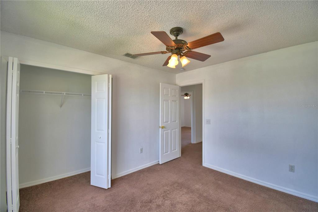 5368 Dahlia Reserve Drive Kissimmee, FL 34758 - Photo 47 of 83 an empty room with closet and a chandelier fan