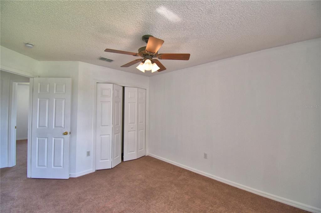 5368 Dahlia Reserve Drive Kissimmee, FL 34758 - Photo 52 of 83 an empty room with a chandelier fan and a ceiling fan