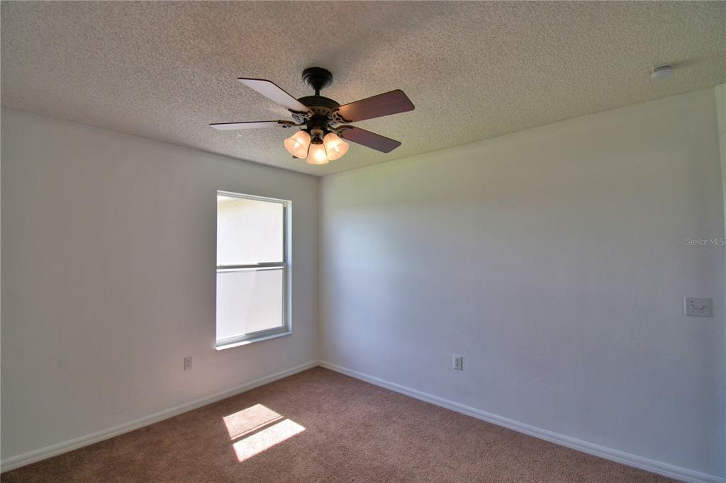 5368 Dahlia Reserve Drive Kissimmee, FL 34758 - Photo 54 of 83 an empty room with a window and a fan