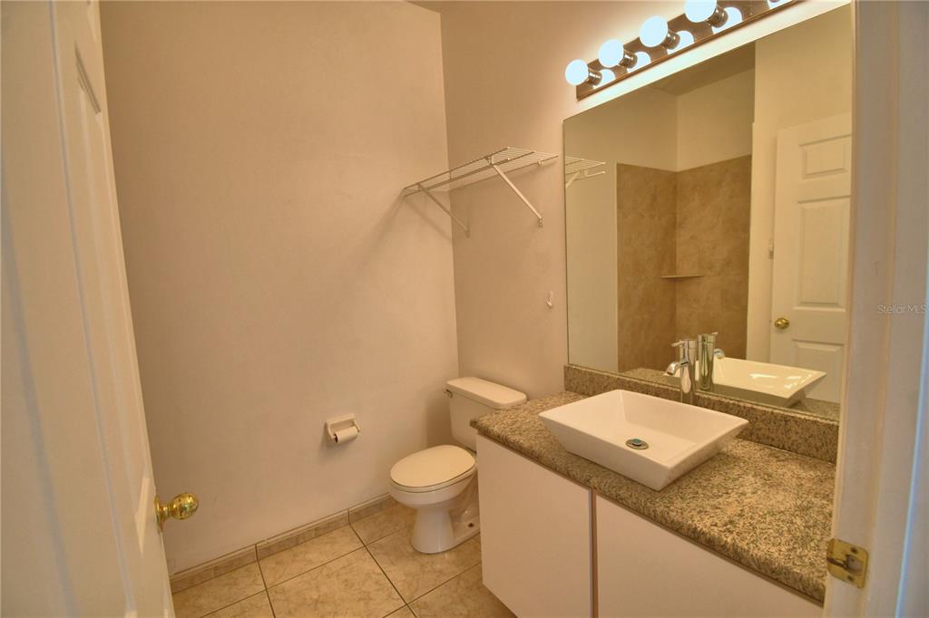 5368 Dahlia Reserve Drive Kissimmee, FL 34758 - Photo 58 of 83 a bathroom with a granite countertop sink toilet and shower