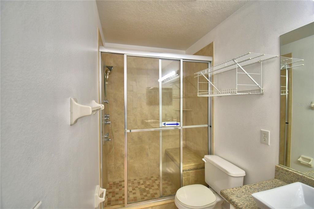 5368 Dahlia Reserve Drive Kissimmee, FL 34758 - Photo 64 of 83 a bathroom with a toilet and a shower