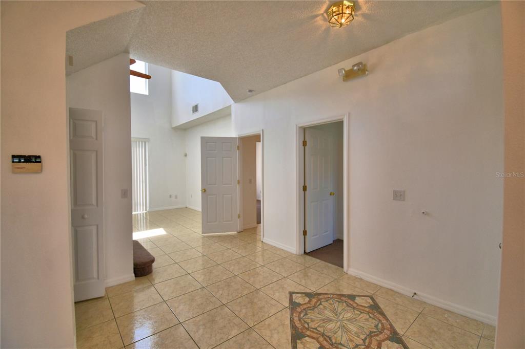 5368 Dahlia Reserve Drive Kissimmee, FL 34758 - Photo 9 of 83 a view of a hallway with bathroom and bathroom