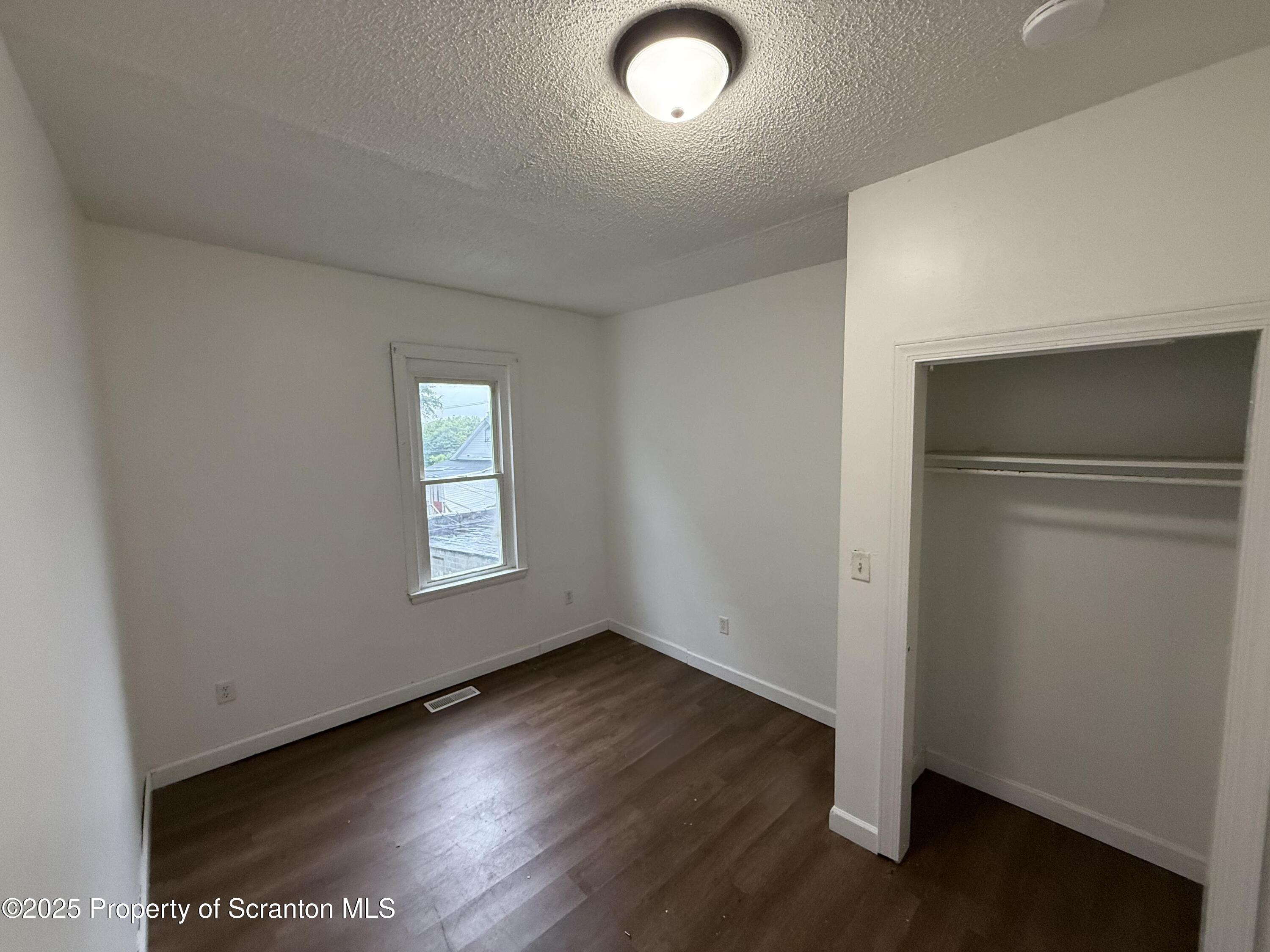 3 Miller Street Pittston, PA 18640 - Photo 11 of 15 an empty room with wooden floor and windows