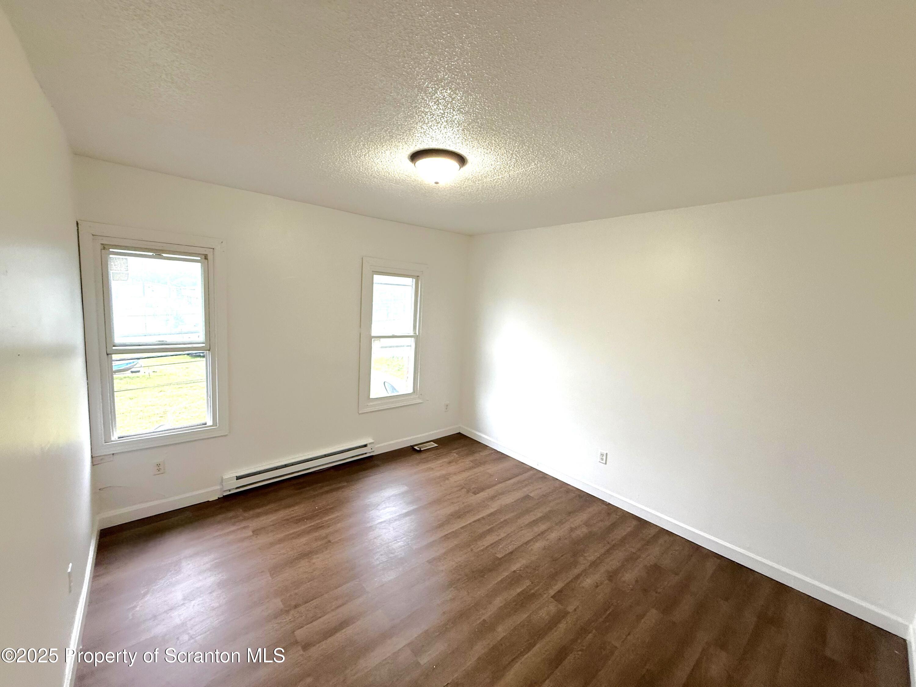 3 Miller Street Pittston, PA 18640 - Photo 12 of 15 an empty room with wooden floor and windows