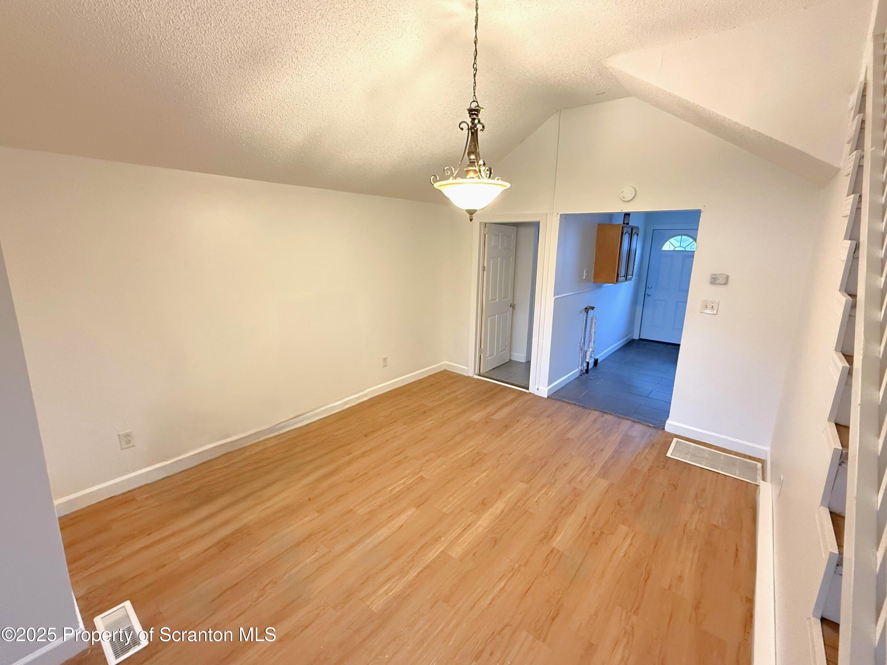 3 Miller Street Pittston, PA 18640 - Photo 5 of 15 a view of an empty room with a chandelier