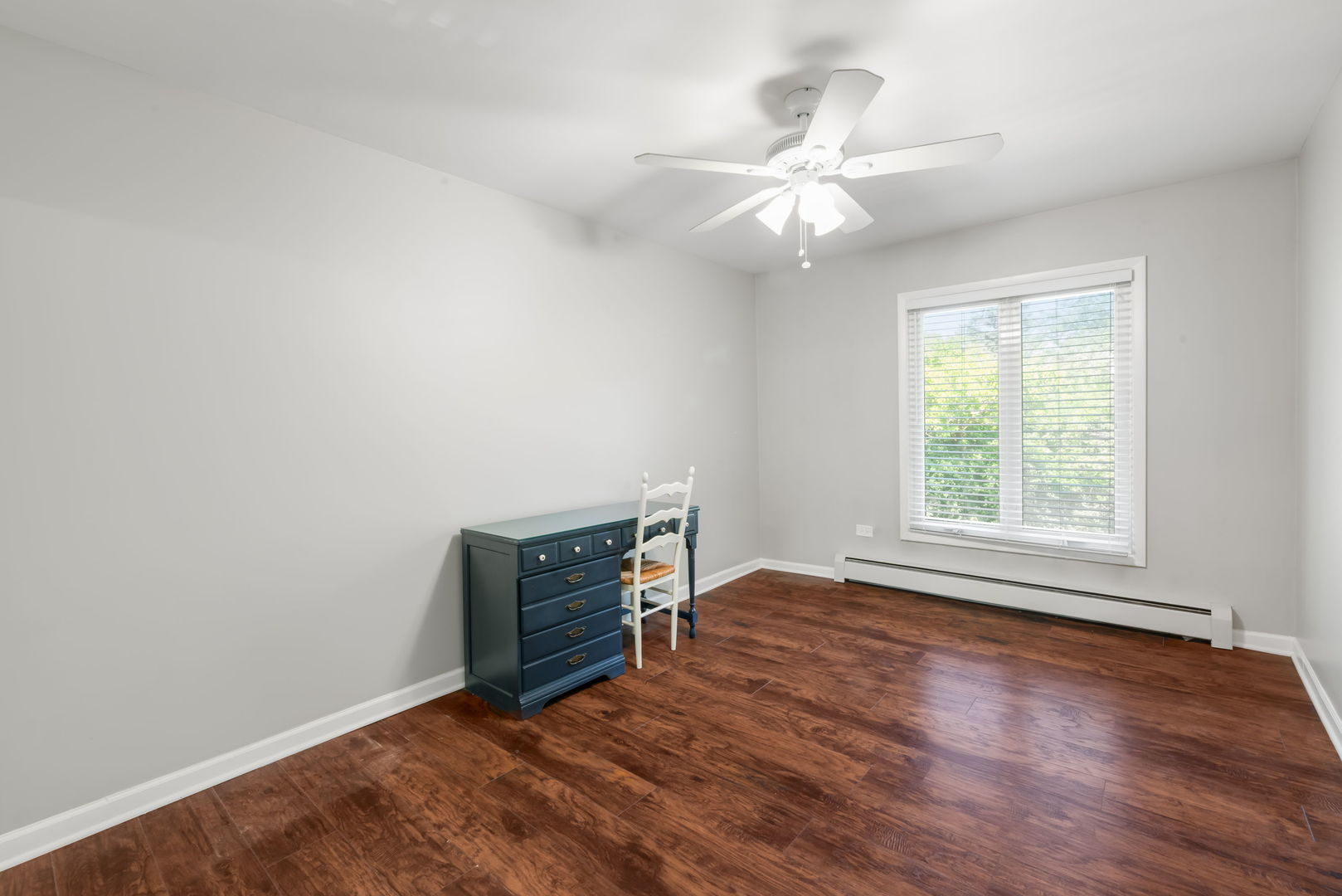 4133 Saratoga Avenue, Unit B220 Downers Grove, IL 60515 - Photo 11 of 18 an empty room with wooden floor fan and windows