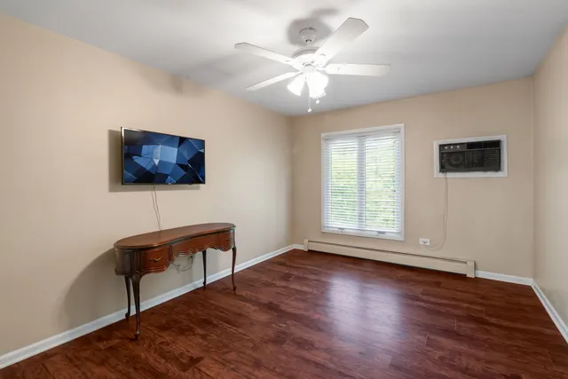 a view of workspace with wooden floor and ceiling fan